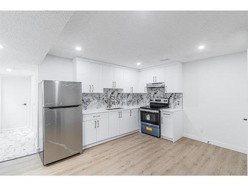 122 Sandstone Drive Nw, Calgary, AB - Indoor Photo Showing Kitchen With Double Sink