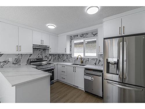 122 Sandstone Drive Nw, Calgary, AB - Indoor Photo Showing Kitchen With Double Sink