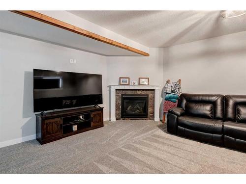 45 Mackenzie Way, Carstairs, AB - Indoor Photo Showing Living Room With Fireplace