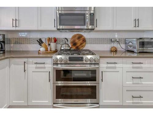 113 Heritage Cove, Cochrane, AB - Indoor Photo Showing Kitchen With Upgraded Kitchen