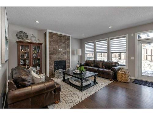 113 Heritage Cove, Cochrane, AB - Indoor Photo Showing Living Room With Fireplace