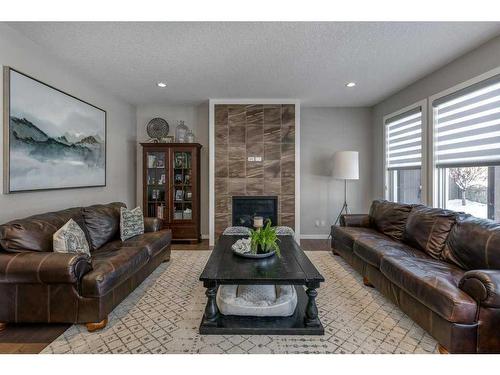 113 Heritage Cove, Cochrane, AB - Indoor Photo Showing Living Room With Fireplace