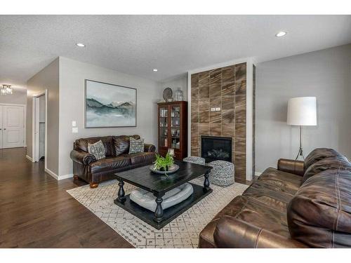 113 Heritage Cove, Cochrane, AB - Indoor Photo Showing Living Room With Fireplace