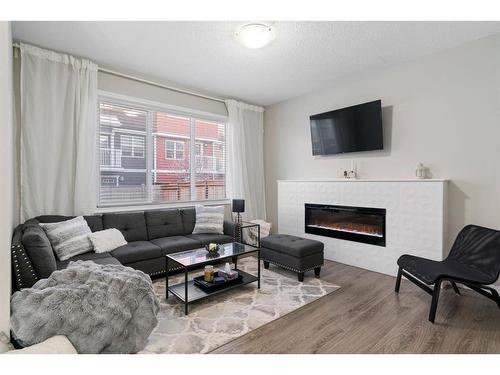 22 Kingfisher Crescent Se, Airdrie, AB - Indoor Photo Showing Living Room With Fireplace