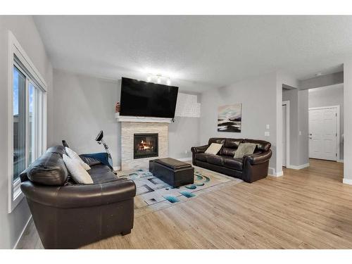 247 Kinniburgh Road, Chestermere, AB - Indoor Photo Showing Living Room With Fireplace