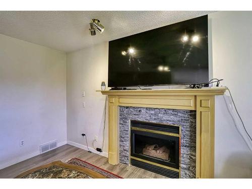 250 Coral Keys Court Ne, Calgary, AB - Indoor Photo Showing Living Room With Fireplace