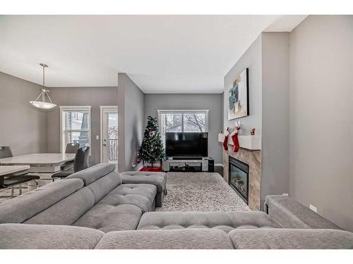 453 Copperpond Landing Se, Calgary, AB - Indoor Photo Showing Living Room With Fireplace