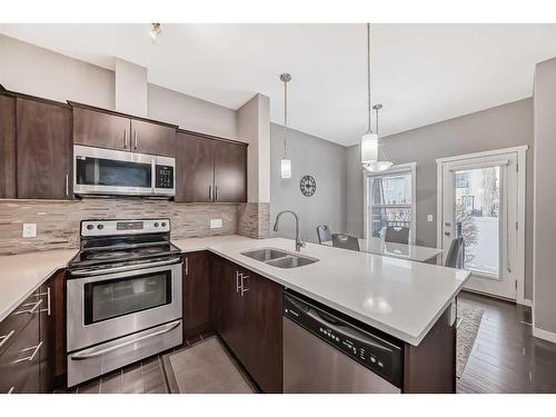 453 Copperpond Landing Se, Calgary, AB - Indoor Photo Showing Kitchen With Stainless Steel Kitchen With Double Sink With Upgraded Kitchen