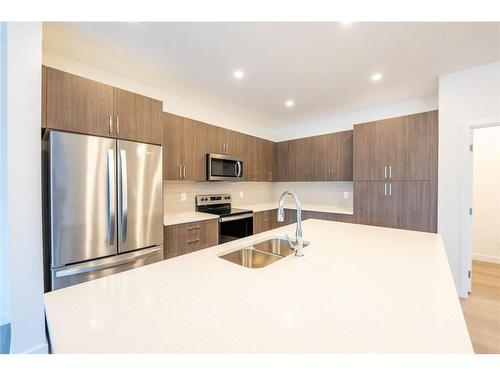 333 Baneberry Way Sw, Airdrie, AB - Indoor Photo Showing Kitchen With Double Sink With Upgraded Kitchen