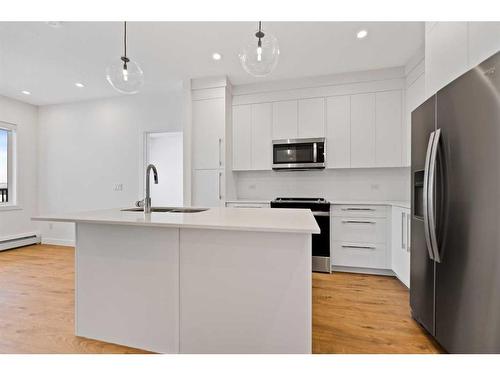 2411-111 Wolf Creek Drive Se, Calgary, AB - Indoor Photo Showing Kitchen With Stainless Steel Kitchen With Upgraded Kitchen