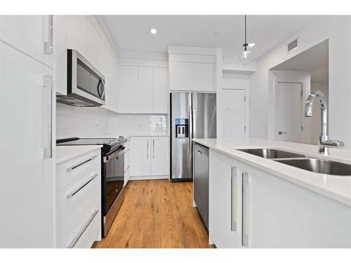 2411-111 Wolf Creek Drive Se, Calgary, AB - Indoor Photo Showing Kitchen With Stainless Steel Kitchen With Double Sink With Upgraded Kitchen