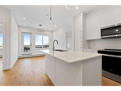 2411-111 Wolf Creek Drive Se, Calgary, AB - Indoor Photo Showing Kitchen With Double Sink With Upgraded Kitchen