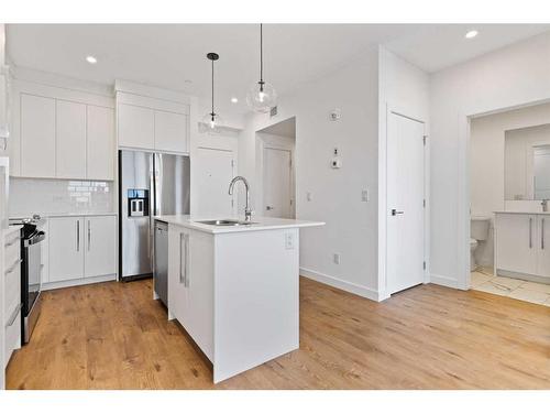 2411-111 Wolf Creek Drive Se, Calgary, AB - Indoor Photo Showing Kitchen With Stainless Steel Kitchen With Upgraded Kitchen