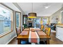 325 De Foras Close Nw, High River, AB  - Indoor Photo Showing Dining Room With Fireplace 