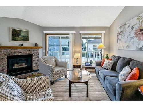 325 De Foras Close Nw, High River, AB - Indoor Photo Showing Living Room With Fireplace