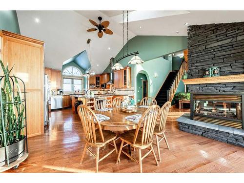 642157 72 Street East, Rural Foothills County, AB - Indoor Photo Showing Dining Room With Fireplace