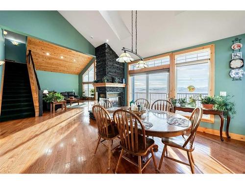 642157 72 Street East, Rural Foothills County, AB - Indoor Photo Showing Dining Room With Fireplace