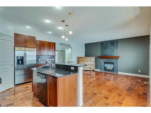 159 Cougarstone Court Sw, Calgary, AB - Indoor Photo Showing Kitchen With Fireplace