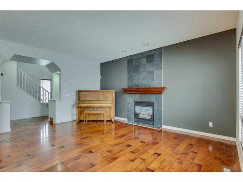 159 Cougarstone Court Sw, Calgary, AB - Indoor Photo Showing Living Room With Fireplace