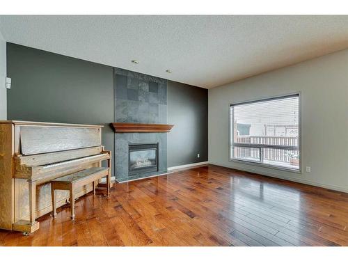 159 Cougarstone Court Sw, Calgary, AB - Indoor With Fireplace