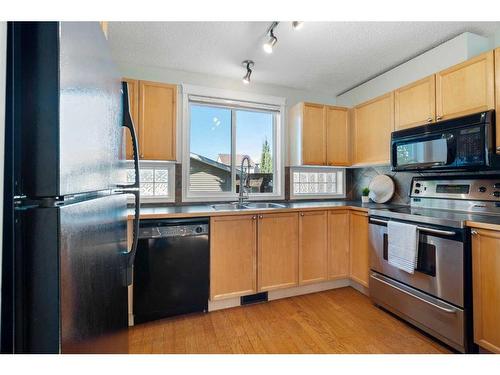 63 Tuscany Springs Rise Nw, Calgary, AB - Indoor Photo Showing Kitchen With Double Sink