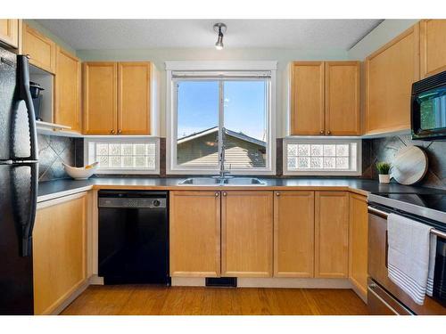 63 Tuscany Springs Rise Nw, Calgary, AB - Indoor Photo Showing Kitchen With Double Sink