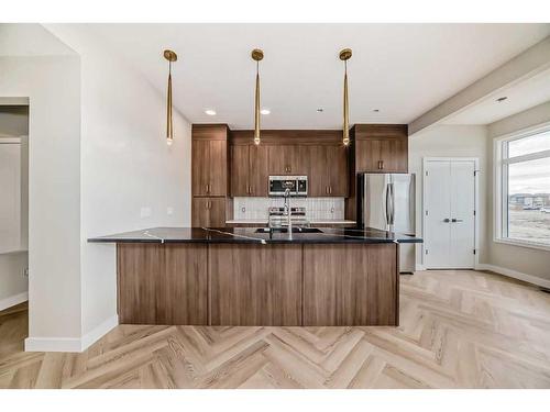 37 Shale Avenue, Cochrane, AB - Indoor Photo Showing Kitchen With Upgraded Kitchen