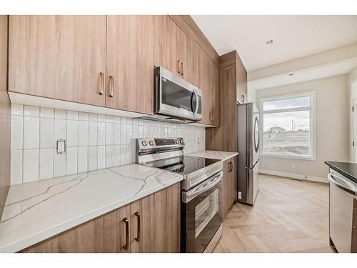 37 Shale Avenue, Cochrane, AB - Indoor Photo Showing Kitchen With Upgraded Kitchen