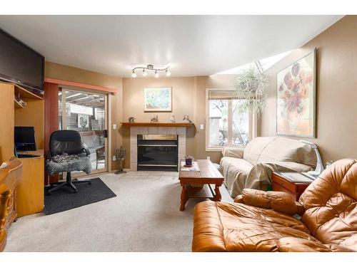 2219 Westmount Road Nw, Calgary, AB - Indoor Photo Showing Living Room With Fireplace