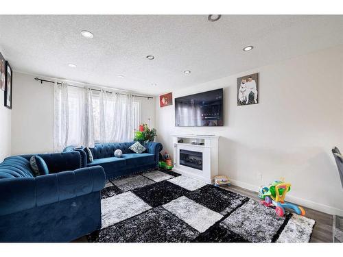 1323 Marlyn Way Ne, Calgary, AB - Indoor Photo Showing Living Room With Fireplace