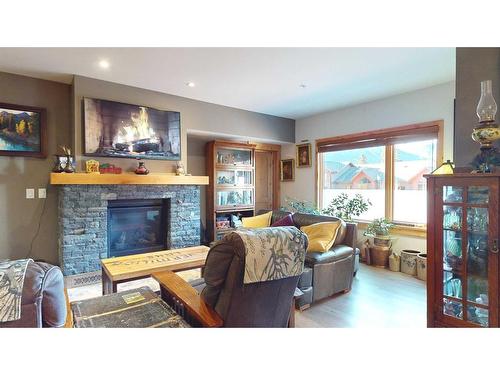 206-707 Spring Creek Drive Se, Canmore, AB - Indoor Photo Showing Living Room With Fireplace