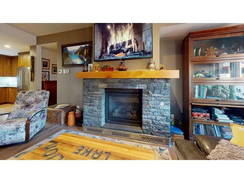 206-707 Spring Creek Drive Se, Canmore, AB - Indoor Photo Showing Living Room With Fireplace