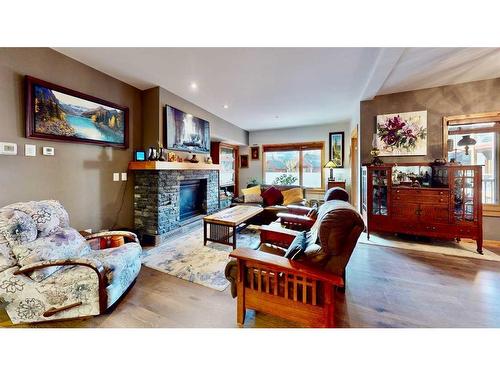 206-707 Spring Creek Drive Se, Canmore, AB - Indoor Photo Showing Living Room With Fireplace