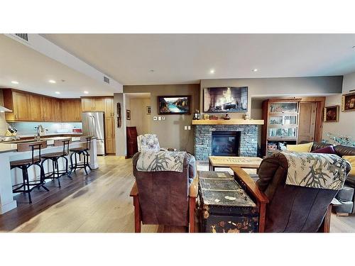 206-707 Spring Creek Drive Se, Canmore, AB - Indoor With Fireplace