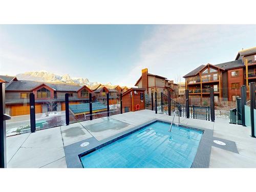 206-707 Spring Creek Drive Se, Canmore, AB - Outdoor With In Ground Pool