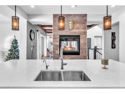 49 303 Avenue West, Rural Foothills County, AB - Indoor Photo Showing Kitchen With Fireplace With Double Sink