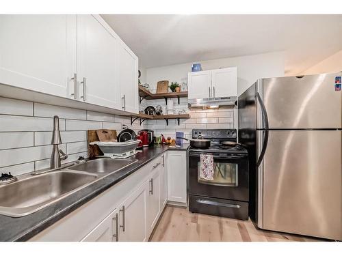 24 Erin Meadow Way Se, Calgary, AB - Indoor Photo Showing Kitchen With Double Sink