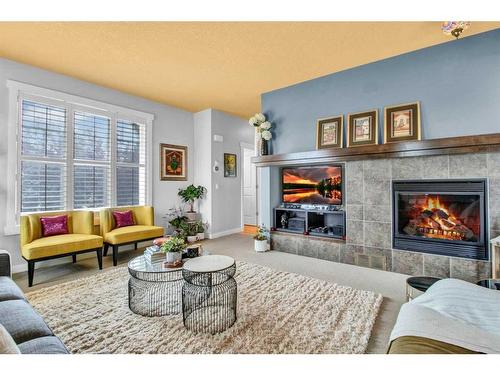 5 Silverado Creek Crescent Sw, Calgary, AB - Indoor Photo Showing Living Room With Fireplace