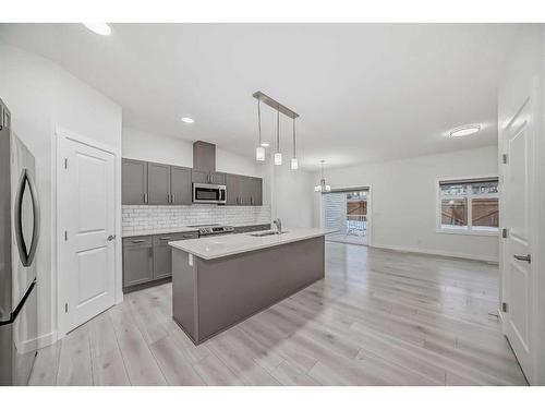 67 Belgian Crescent, Cochrane, AB - Indoor Photo Showing Kitchen With Upgraded Kitchen