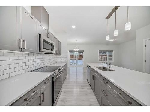 67 Belgian Crescent, Cochrane, AB - Indoor Photo Showing Kitchen With Double Sink With Upgraded Kitchen