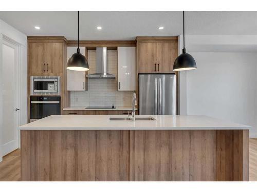 239 Kinniburgh Loop, Chestermere, AB - Indoor Photo Showing Kitchen With Stainless Steel Kitchen With Double Sink With Upgraded Kitchen