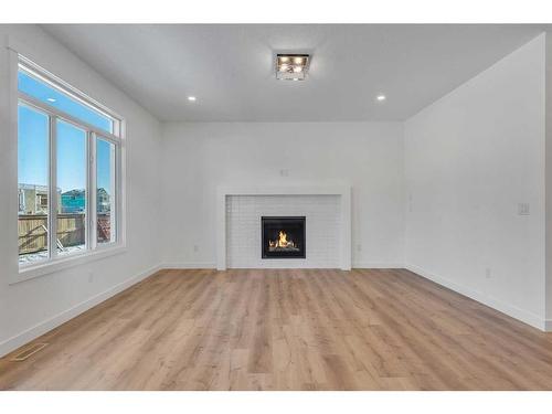 239 Kinniburgh Loop, Chestermere, AB - Indoor Photo Showing Living Room With Fireplace