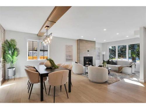 42 Canova Road Sw, Calgary, AB - Indoor Photo Showing Dining Room With Fireplace