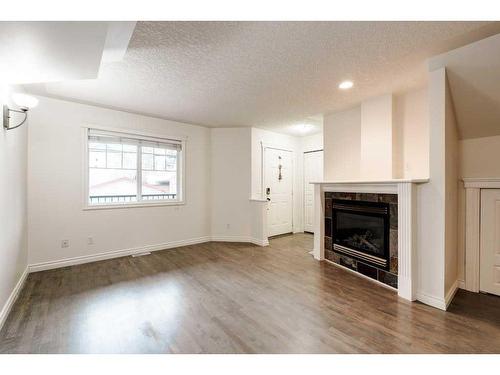 2-433 13 Avenue Ne, Calgary, AB - Indoor Photo Showing Other Room With Fireplace