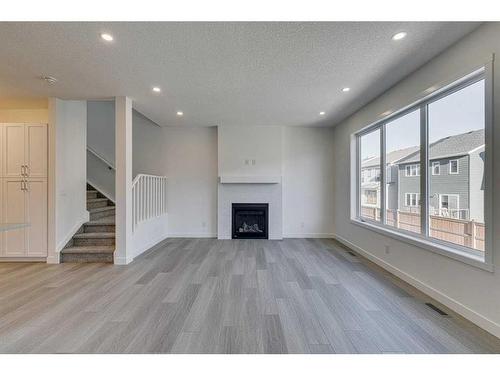 2070 Fowler Road Sw, Airdrie, AB - Indoor Photo Showing Other Room With Fireplace