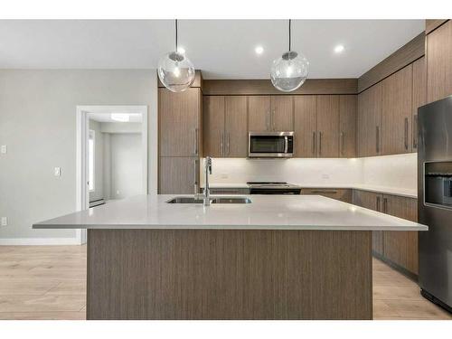 213-383 Smith Street Nw, Calgary, AB - Indoor Photo Showing Kitchen With Stainless Steel Kitchen With Double Sink With Upgraded Kitchen