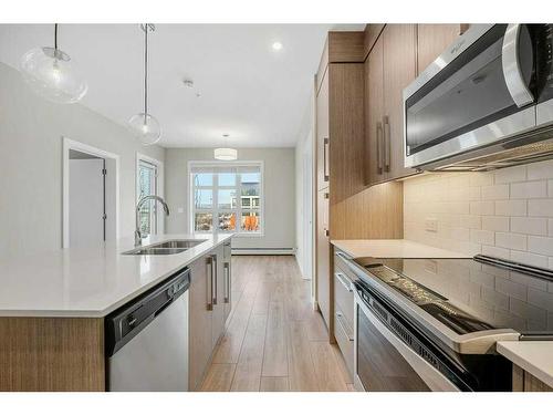 213-383 Smith Street Nw, Calgary, AB - Indoor Photo Showing Kitchen With Stainless Steel Kitchen With Double Sink With Upgraded Kitchen