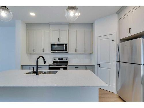 545 Bayview Street Sw, Airdrie, AB - Indoor Photo Showing Kitchen With Stainless Steel Kitchen With Double Sink With Upgraded Kitchen