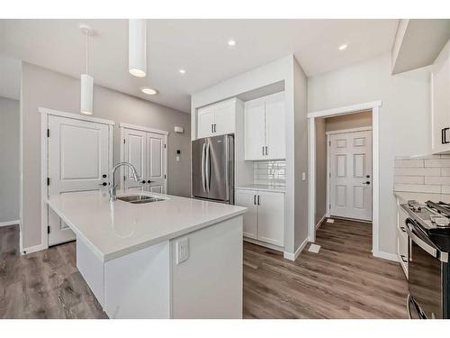 24 Sugarsnap Way Se, Calgary, AB - Indoor Photo Showing Kitchen With Stainless Steel Kitchen With Double Sink With Upgraded Kitchen