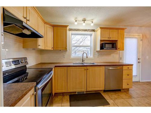 603 Prairie Sound Circle Nw, High River, AB - Indoor Photo Showing Kitchen With Double Sink